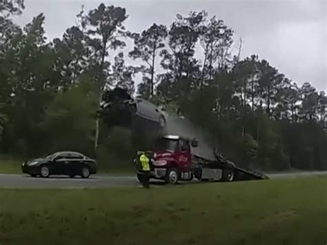 LOWNDES COUNTY, Ga. - A distracted driver hit the ramp of a tow truck on a busy Georgia highway, sending their car soaring through the air in a wild crash that was caught on video. The high-flying ...